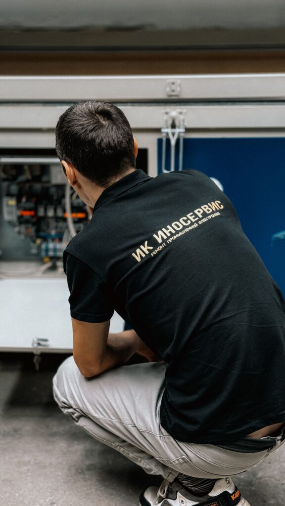 pexels-photo-34054460-34054460 Technician working on complex machinery in an industrial setting.